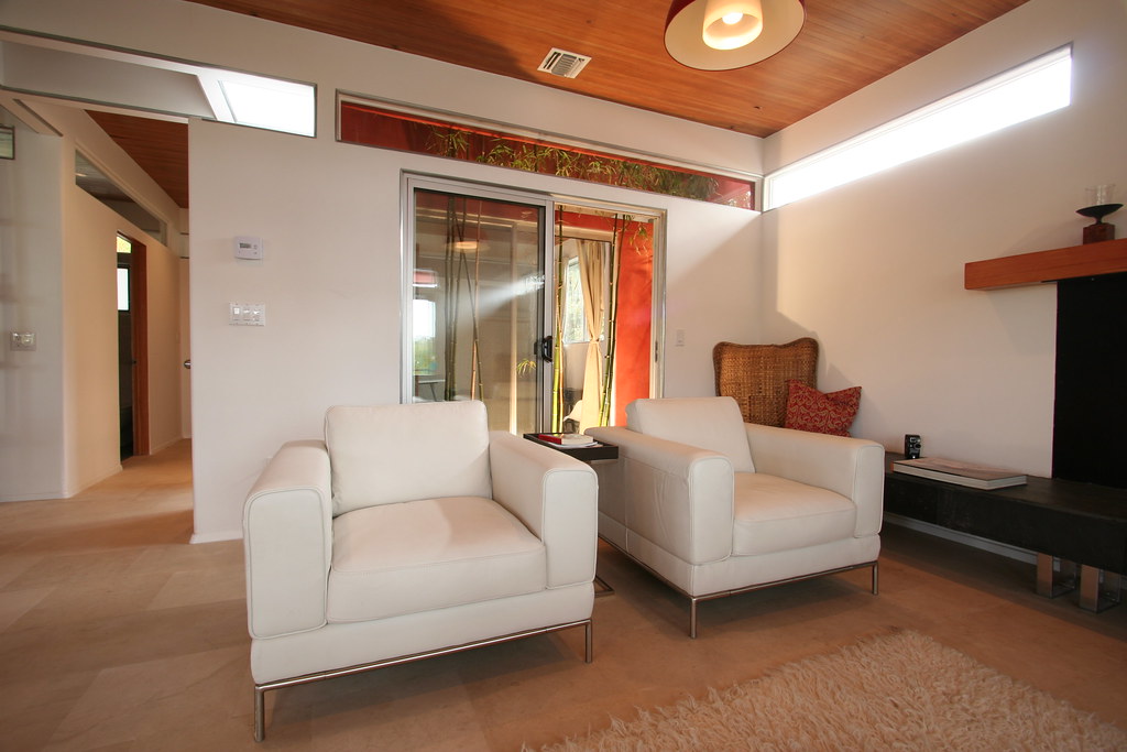 A warmly lit living room with custom pendant lighting