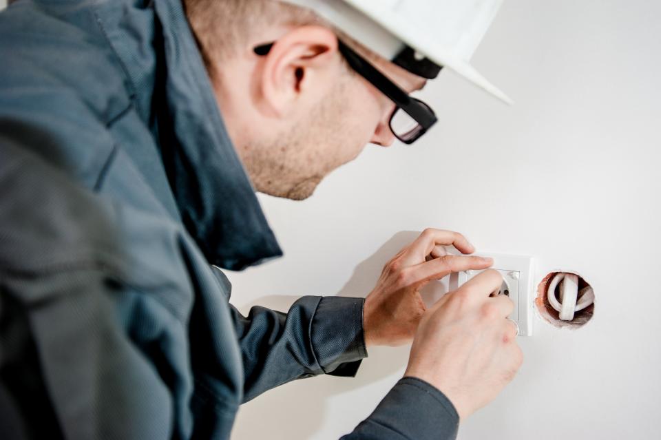 Electrician installing a wall power point